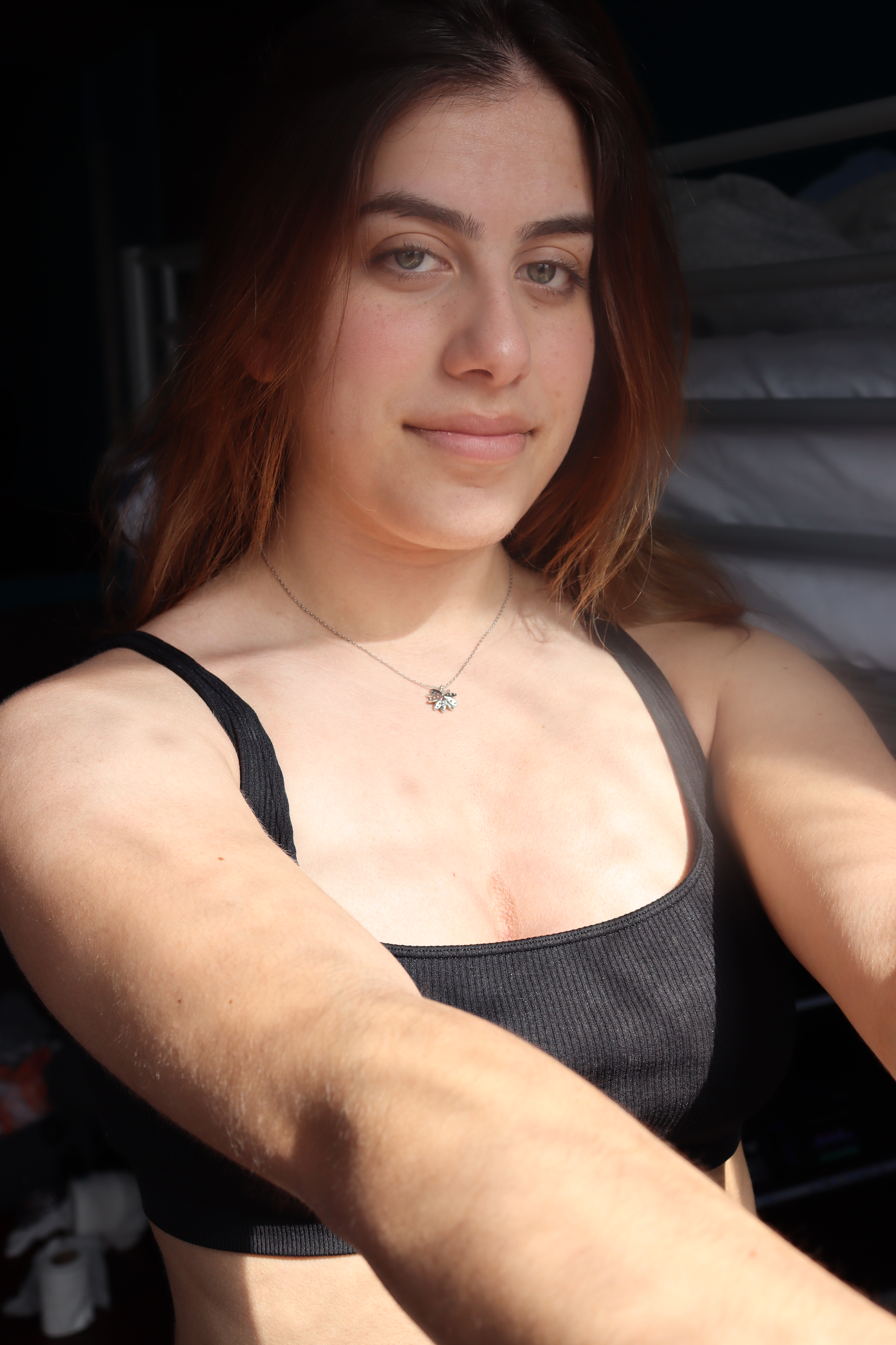An image of a woman looking at the camera with both arms out.